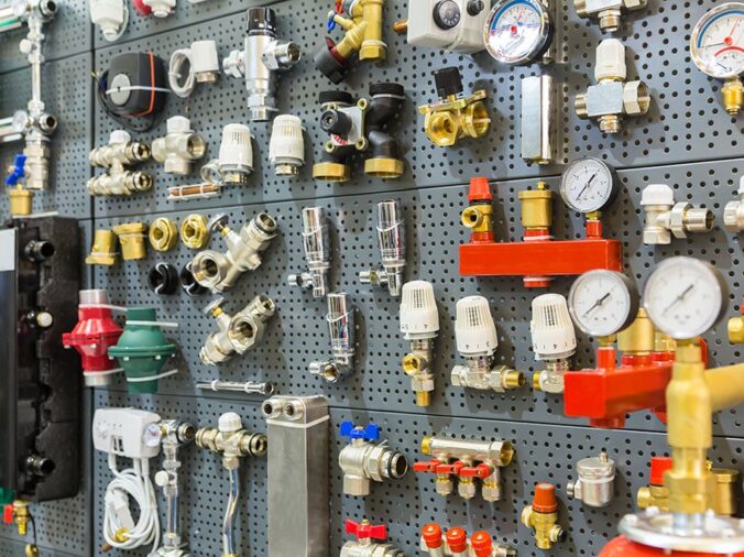 Brass valves and plumbing fittings on display in a plumbing supply store